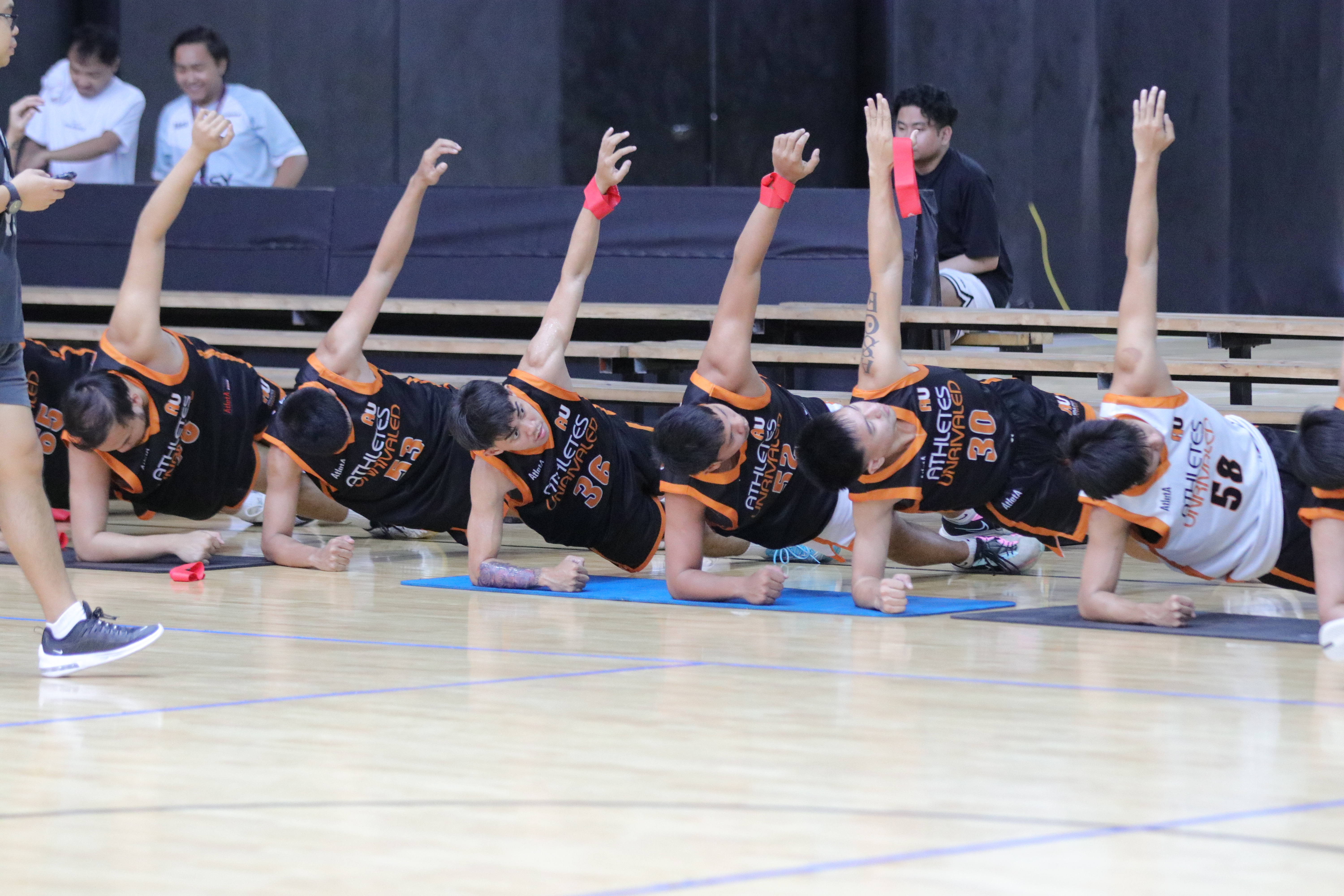Athletes Unrivaled players stretching together before training